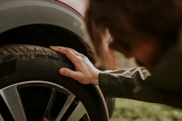 Man checking car tire photo