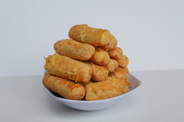 Kaasstengels or Kastengel, is Dutch influenced Indonesian cheese cookies in the form of sticks. Isolated in white background