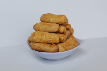 Kaasstengels or Kastengel, is Dutch influenced Indonesian cheese cookies in the form of sticks. Isolated in white background