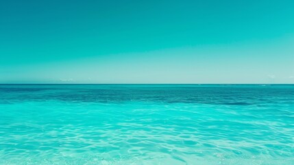 Fototapeta premium Capturing the unbroken horizon where the vibrant turquoise ocean meets the clear blue sky, symbolizing infinite tranquility.