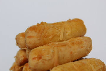 Kaasstengels or Kastengel, is Dutch influenced Indonesian cheese cookies in the form of sticks. Isolated in white background