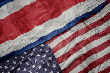 Obraz premium waving colorful flag of united states of america and national flag of costa rica.