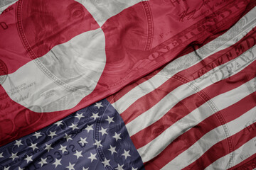 Obraz premium waving colorful flag of united states of america and national flag of greenland.