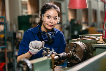 Portrait happy engineer worker with safety eyes protection glasses professional working with metal lathe milling machine heavy industry factory. - 801368905