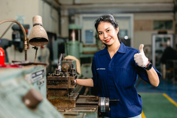 Portrait engineer worker thumbs up professional working in metal lathe milling machine heavy...