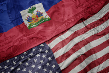 waving colorful flag of united states of america and national flag of haiti.