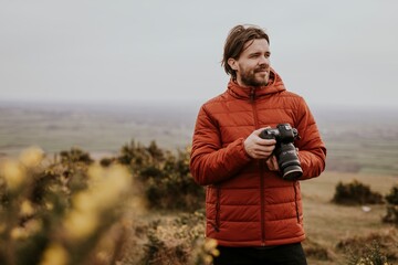 Photographer holding camera, nature photography