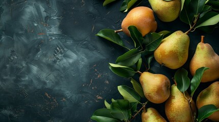 Fresh pears with green leaves on a textured dark background, top view layout.