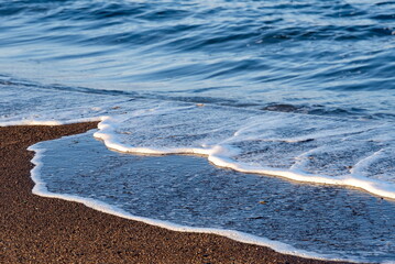 Russia. The Far East. The Kuril Islands. The remains of destroyed waves on volcanic sand on the shore of the Sea of Okhotsk island of Iturup.