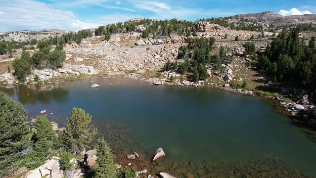 An aerial flight over a small alpine lake along the Beartooth Highway in Montana, northeast of Yellowstone National Park.