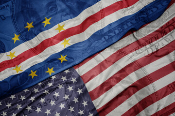 waving colorful flag of united states of america and national flag of cape verde on the dollar money background. finance concept.