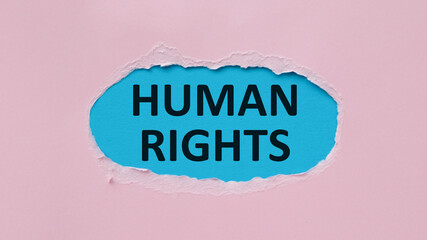 Torn paper with on Pink background with a frame for text. Text Human Rights