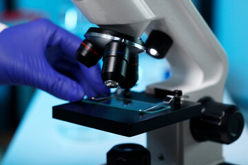 Scientist working with modern microscope indoors, closeup