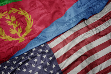 waving colorful flag of united states of america and national flag of eritrea on the dollar money...