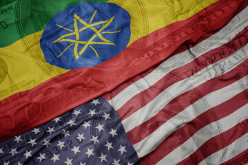 waving colorful flag of united states of america and national flag of ethiopia on the dollar money...