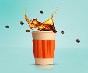 Aromatic coffee splashing in takeaway paper cup and flying roasted beans on turquoise background