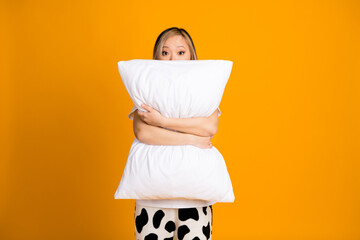 Photo of pretty charming cute woman wear white trendy pajama hold pillow isolated on yellow color...