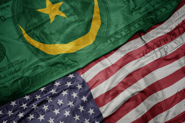 waving colorful flag of united states of america and national flag of mauritania on the dollar money background. finance concept.