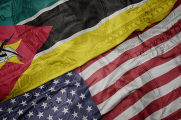 waving colorful flag of united states of america and national flag of mozambique on the dollar...