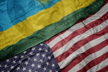 waving colorful flag of united states of america and national flag of rwanda on the dollar money...