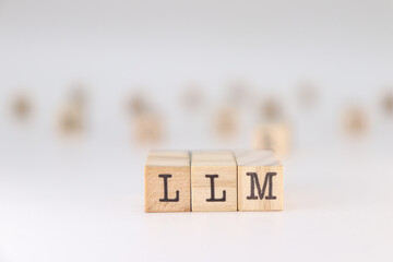 Abbreviation LLM. Concept of Large Language Model written on wooden cubes isolated on white background.