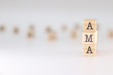 AMA word. Concept of ask me anything written on wooden cubes isolated on white background.