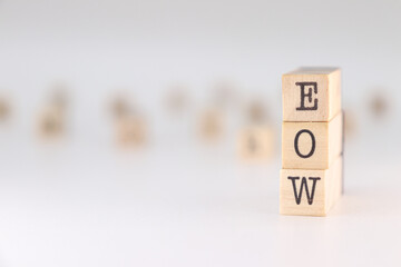 Abbreviation EOW. Concept for End Of Week written on wooden cubes isoated on white background.