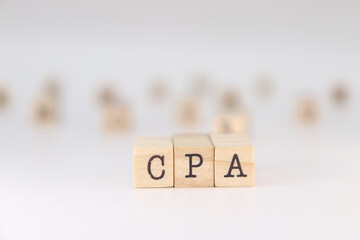 CPA acronym. Concept of Certified Public Accountant written on wooden cubes isolated on white background.