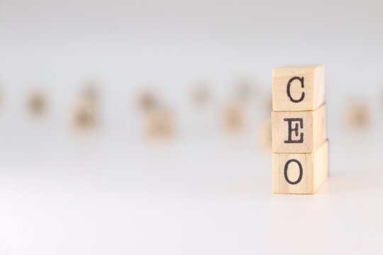 Acronym CEO written on wooden cubes isolated on white background . Concept text for chief executive officer
