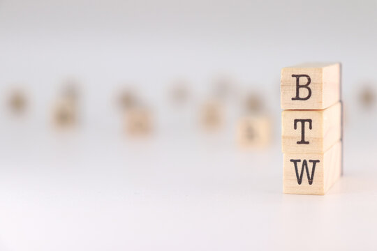 BTW acronym. Concept of by the way written on wooden cubes isolated on white background.