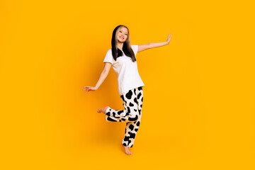 Full length photo of good mood lovely cute woman wear white trendy pajama isolated on yellow color...