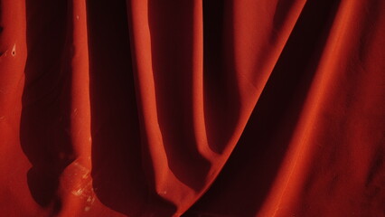 red wrinkled fabric with shadows as a background
