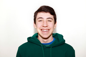 teenager looking at camera laughing on white background