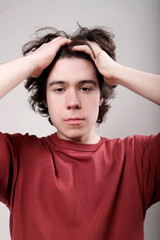 worried young man with hands on his head
