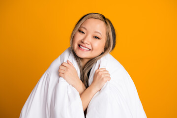 Photo of pretty cute nice woman wrapped warm blanket bedclothes isolated on yellow color background