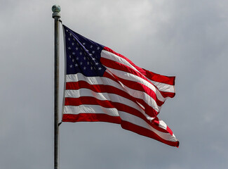 United States flag flying high and at sporting event
