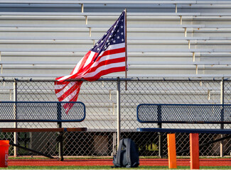 United States flag flying high and at sporting event