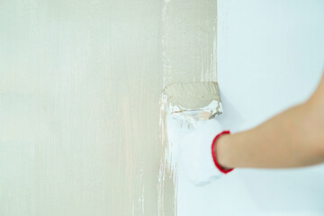 Woman painting the wall by herself.