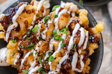 Corn and Chicken Tempura close-up in black bowl