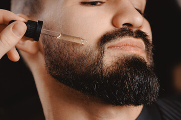 Oil for beard growth, hipster male use cosmetic pipette, barber shop skin and hair care for man