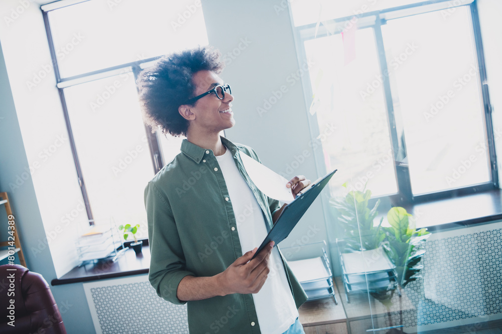 Poster Photo of cool smart employee wear khaki shirt eyeglasses preparing contract writing clipboard indoors workstation workplace