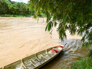 a river with wooden boat 