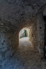 Obraz premium Sauve, France - 04 16 2024: Panoramic View of a typical white Occitan stone passage of the Village on the hill .