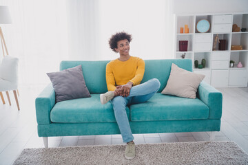 Full size photo of nice young man sit couch think wear yellow pullover white interior apartment...