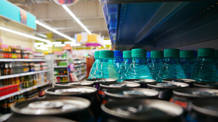 Many blue plastic bottles of carbonated water with mineral water in a supermarket