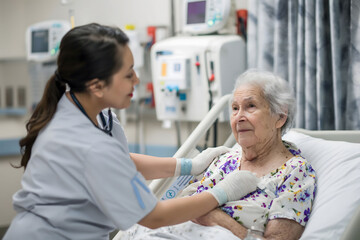 Fototapeta premium Nurse take care of old senior sick woman patient at hospital room. International Nurses Day concept.