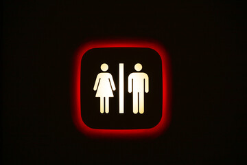 Unisex toilet sign on a black wall.