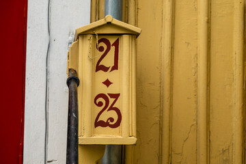 Vintage wooden mailbox marked 21 23.