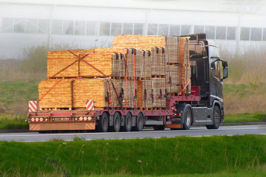 Truck delivering materials and machinery to the construction site.