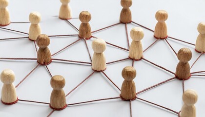 Fototapeta premium group of wooden people are connected by strings, forming a network. Concept of interconnectedness and collaboration, as the people are all linked together